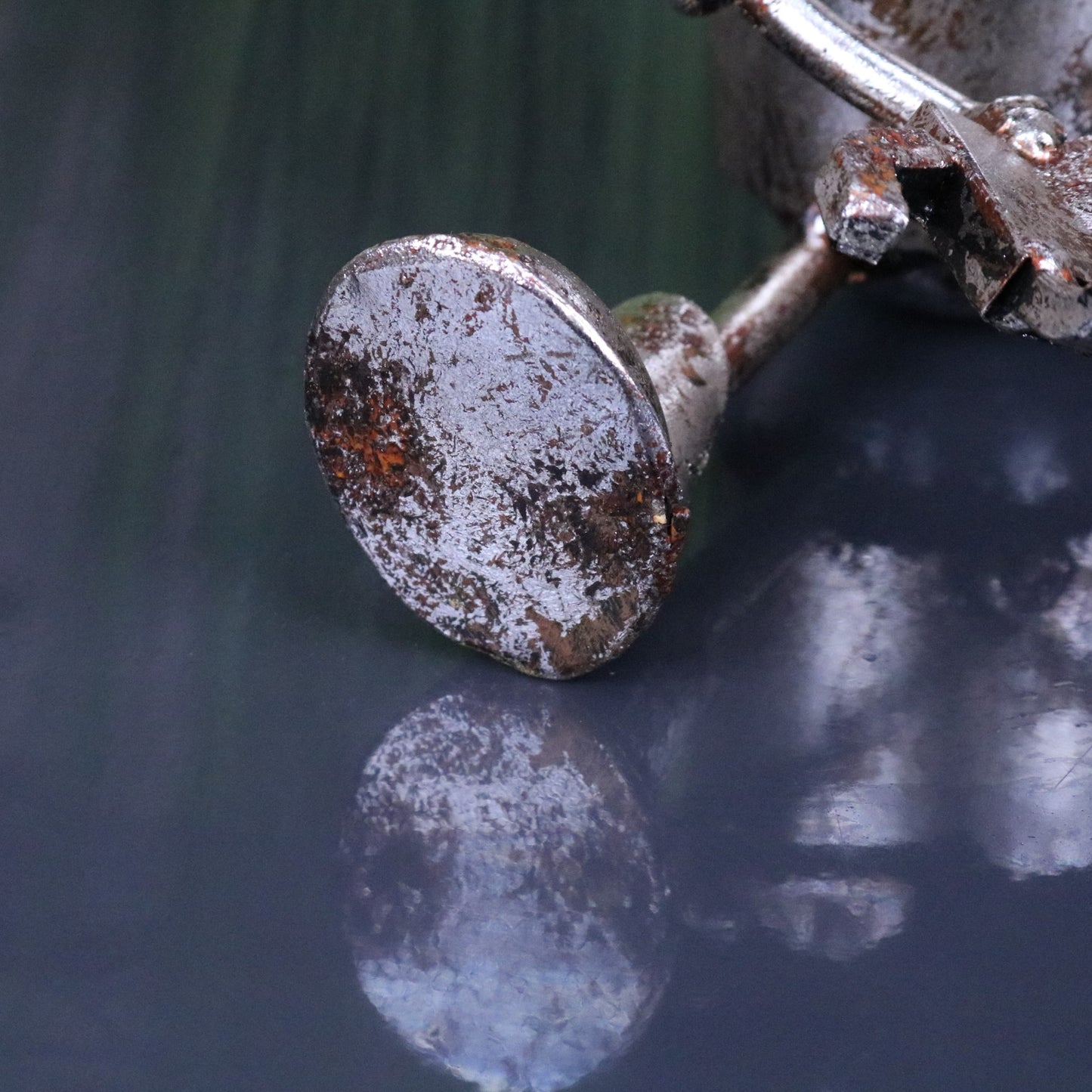 Silver Siting Robot Ornament Springy Bobble Head - Closeup of Foot